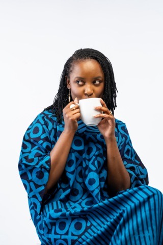 A host mid-sip, looking off camera